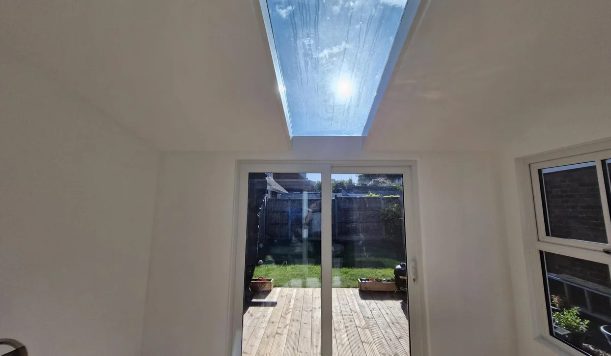 Interior of a Warwickshire bespoke garden office with desk, dual monitors and warm natural light